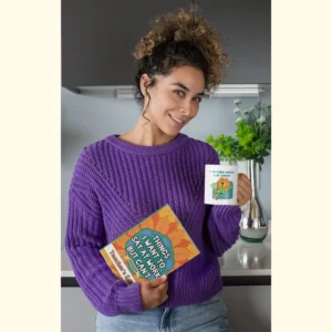 Woman Holding Funny Teacher Coloring Book and Mug That Says I Wish May Would Last Forever